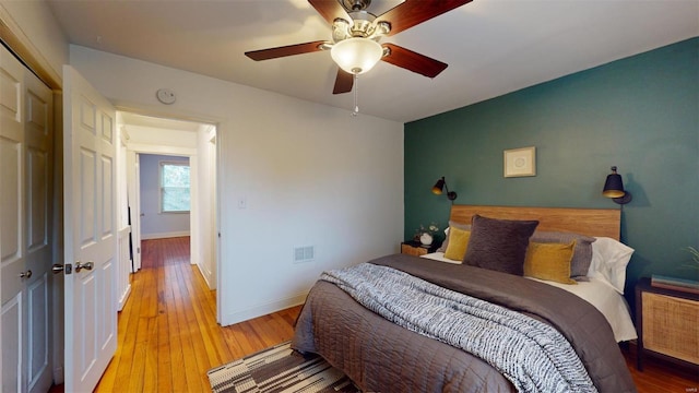 bedroom with ceiling fan and light hardwood / wood-style floors