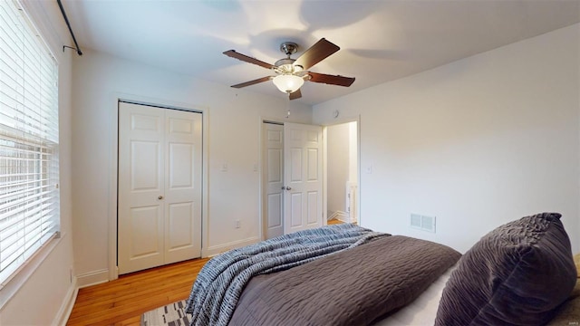 bedroom with ceiling fan and light hardwood / wood-style flooring