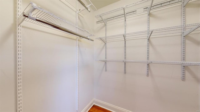 walk in closet with hardwood / wood-style floors