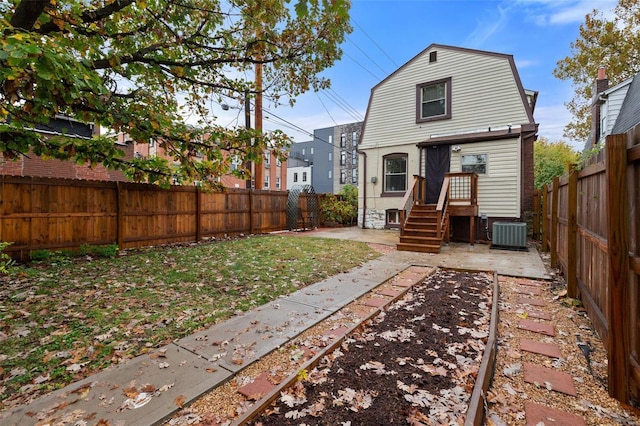 back of property with central AC and a patio area