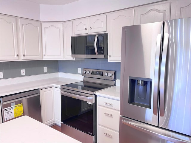 kitchen featuring appliances with stainless steel finishes, white cabinetry, and tasteful backsplash