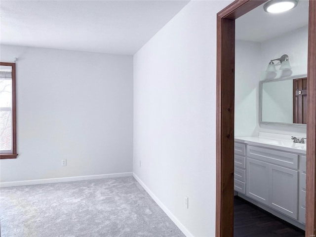 carpeted spare room featuring sink