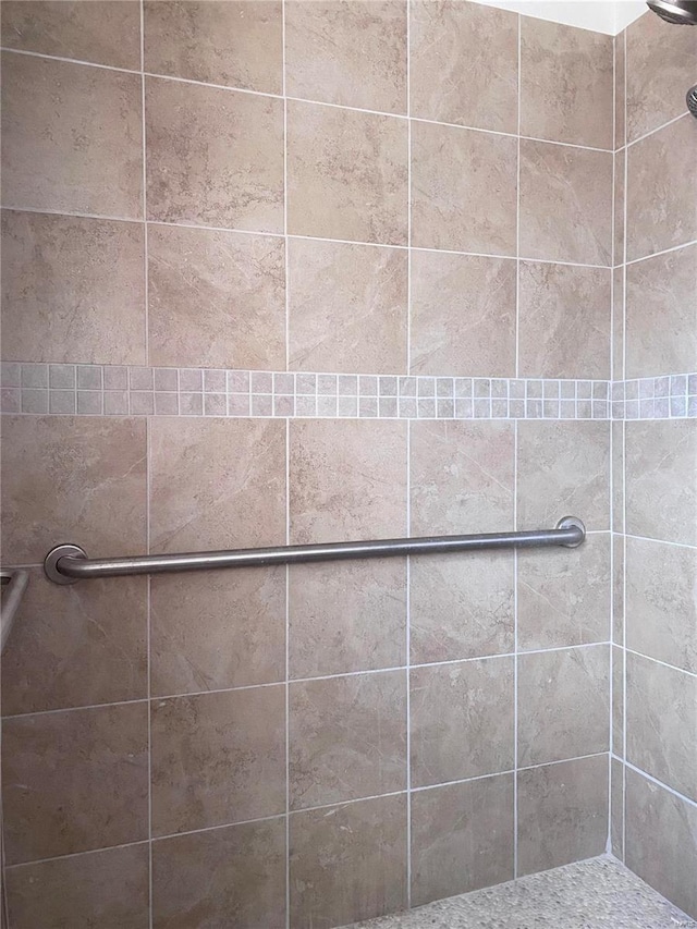 bathroom with a tile shower