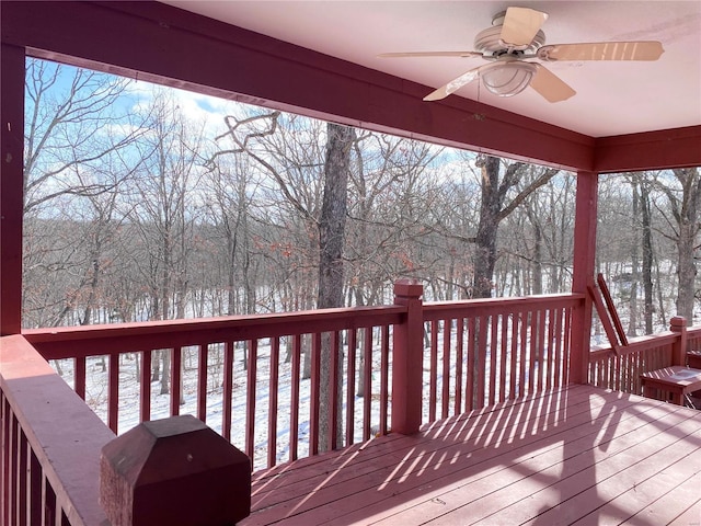 snow covered deck with ceiling fan and a grill