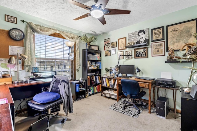 office area featuring light carpet, ceiling fan, and a textured ceiling