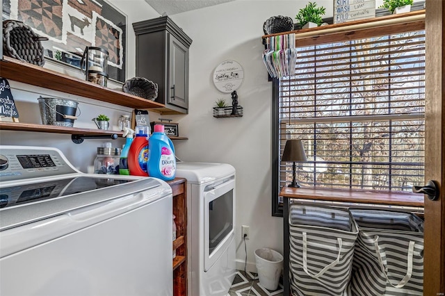 washroom featuring separate washer and dryer, a textured ceiling, and cabinets