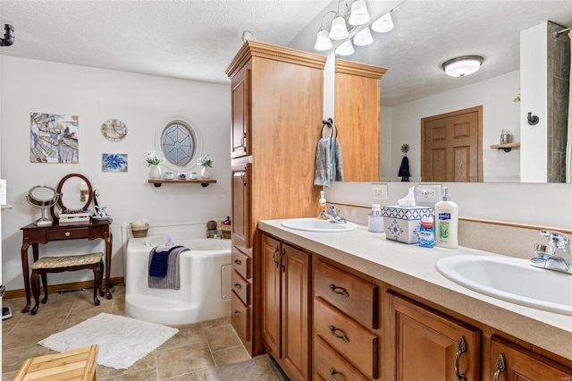 bathroom with a tub to relax in, vanity, and a textured ceiling