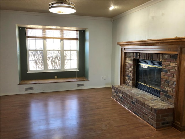 unfurnished living room featuring ornamental molding, dark wood-type flooring, and a fireplace