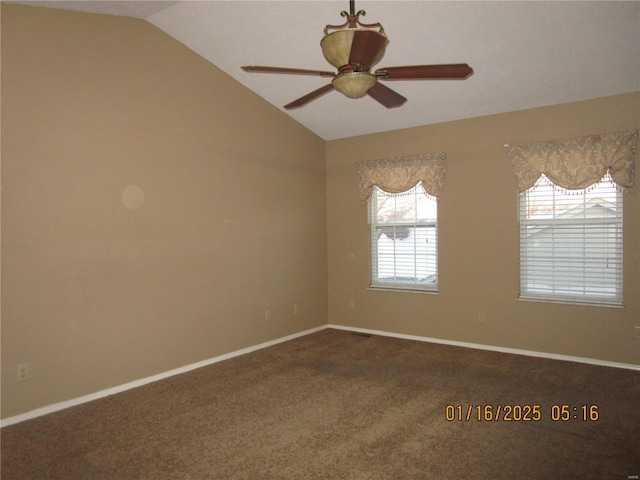 carpeted spare room featuring vaulted ceiling and ceiling fan