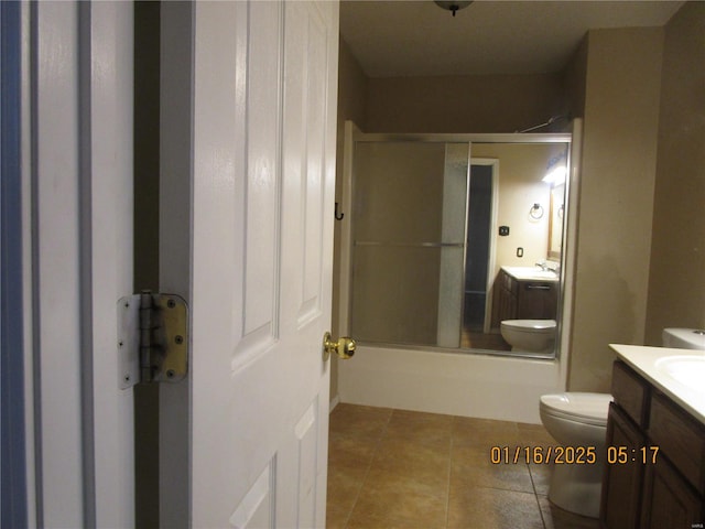 full bathroom with tile patterned floors, vanity, toilet, and combined bath / shower with glass door