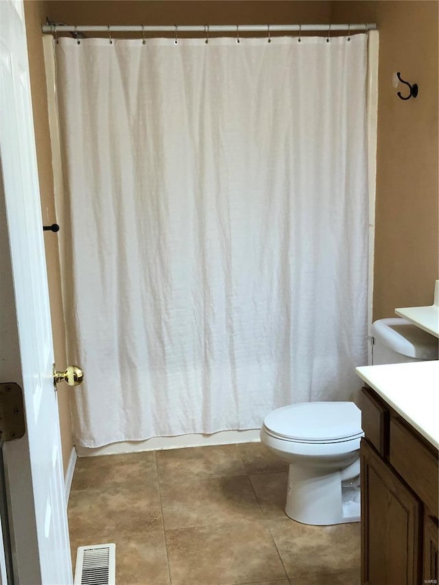 bathroom with vanity, tile patterned floors, and toilet