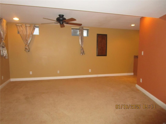 basement featuring carpet floors and ceiling fan