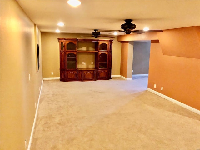 unfurnished living room with ceiling fan and carpet