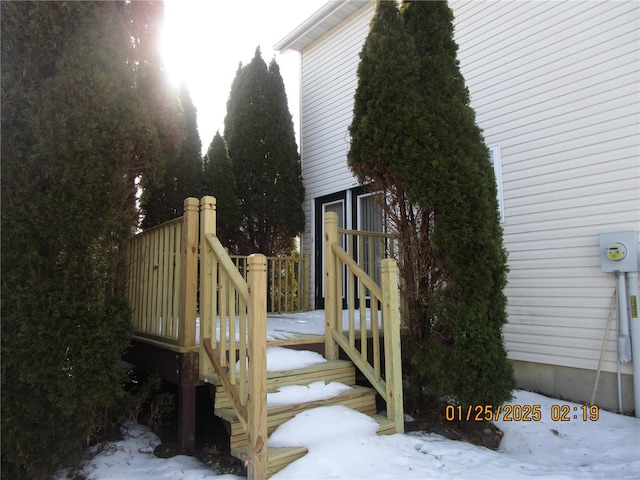 view of snowy exterior featuring a deck