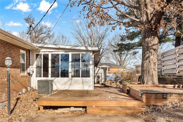 deck featuring cooling unit and a sunroom