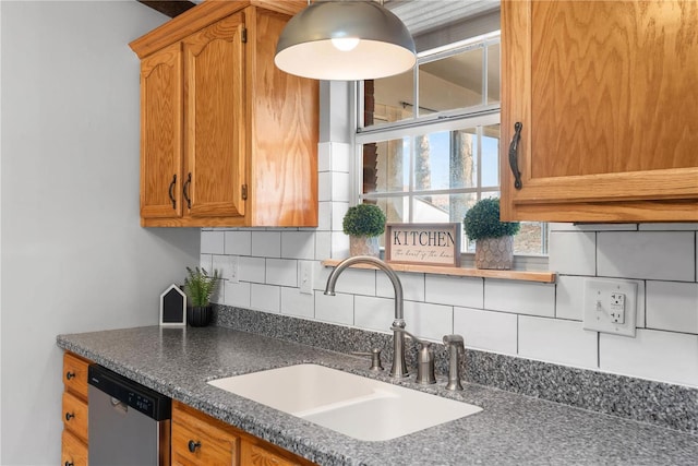 kitchen with tasteful backsplash, dishwasher, and sink