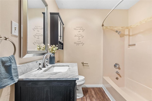 full bathroom featuring vanity, hardwood / wood-style floors, shower / bathtub combination, and toilet