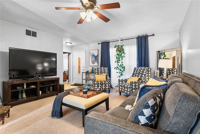 carpeted living room with ceiling fan