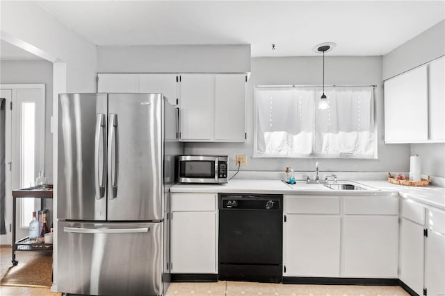 kitchen with white cabinets, hanging light fixtures, and stainless steel appliances