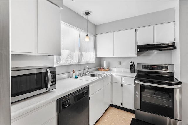 kitchen with decorative light fixtures, white cabinets, sink, and stainless steel appliances