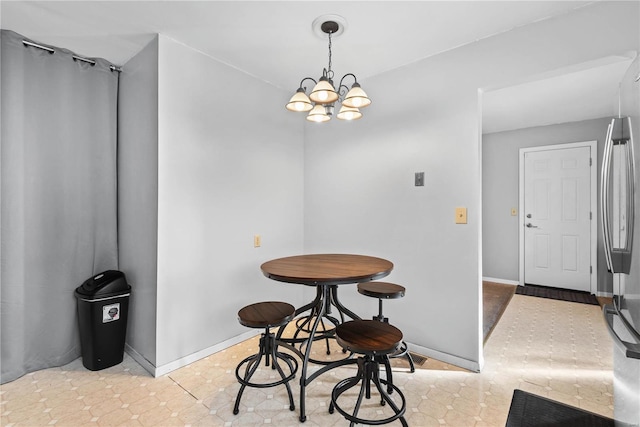 tiled dining space with a notable chandelier