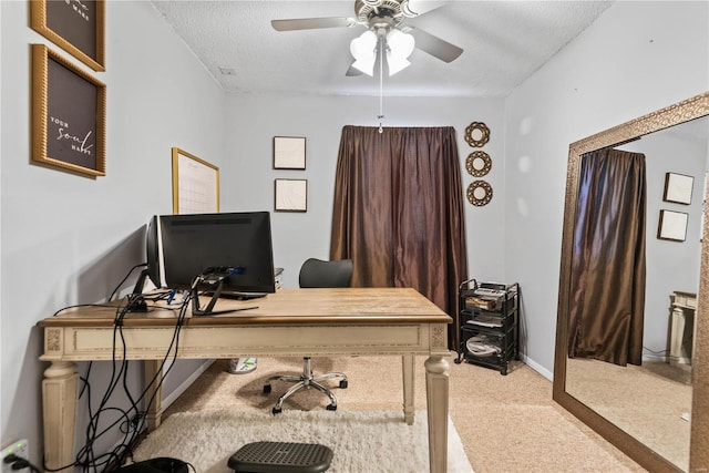 carpeted office with ceiling fan and a textured ceiling