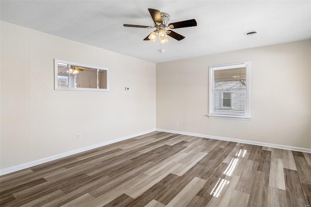 spare room with hardwood / wood-style flooring and ceiling fan