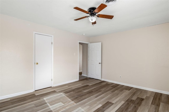 unfurnished room featuring hardwood / wood-style floors and ceiling fan