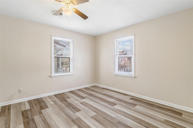 spare room featuring light wood-type flooring and ceiling fan