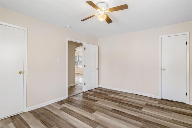 unfurnished room featuring hardwood / wood-style floors and ceiling fan