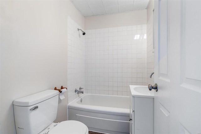 full bathroom with toilet, tiled shower / bath, and vanity