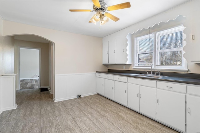 kitchen featuring sink, ceiling fan, white cabinets, and light hardwood / wood-style floors