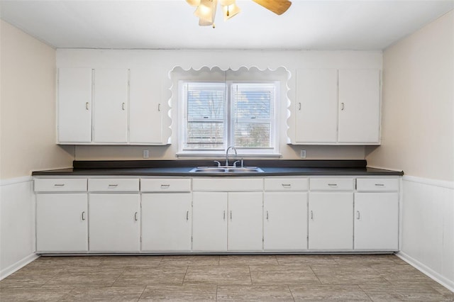 kitchen with sink, white cabinets, and ceiling fan