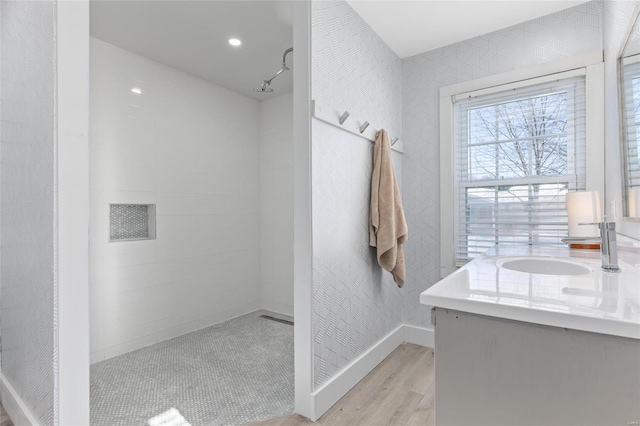 bathroom with hardwood / wood-style floors, vanity, and track lighting