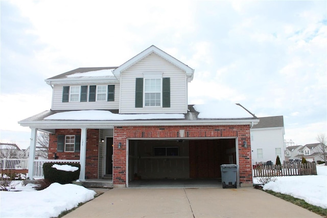 view of front of house featuring covered porch and a garage