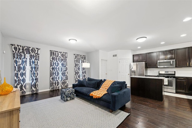 living room with dark hardwood / wood-style flooring