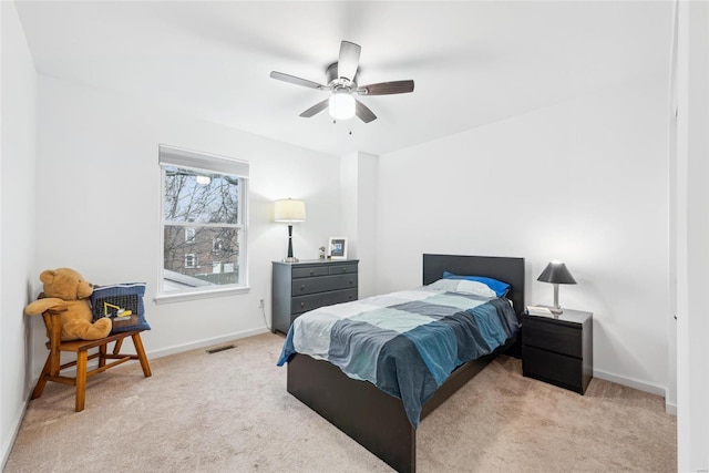 bedroom featuring light carpet and ceiling fan