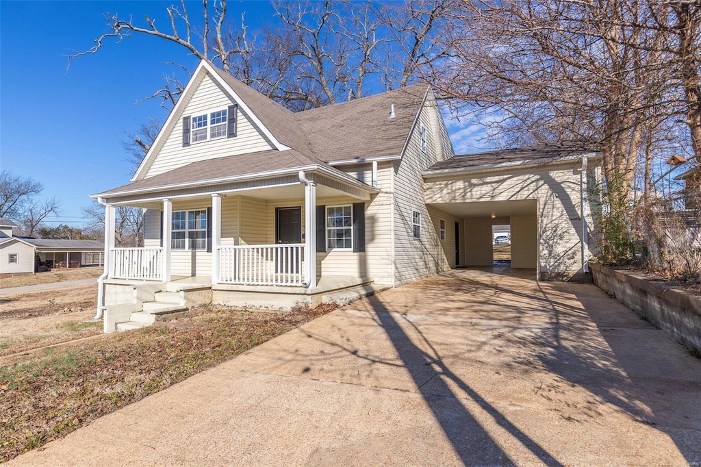 view of front of home featuring covered porch and a carport