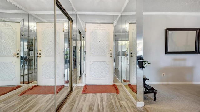 entrance foyer with crown molding, wood-type flooring, and a textured ceiling