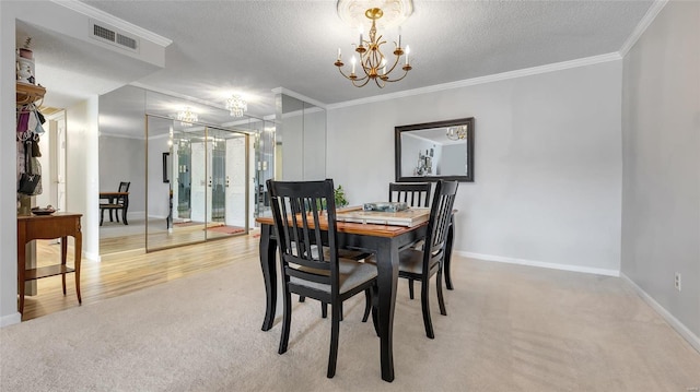 dining room featuring crown molding, a chandelier, carpet floors, and a textured ceiling