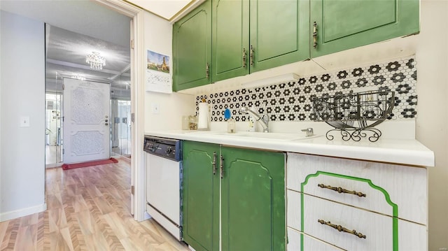 kitchen featuring sink, backsplash, green cabinets, white dishwasher, and light hardwood / wood-style flooring