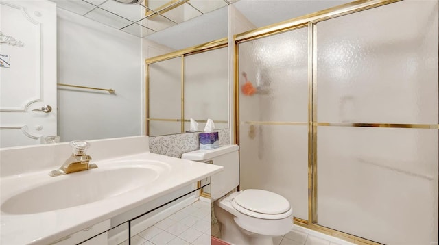 bathroom with sink, a shower with shower door, tile patterned floors, and toilet