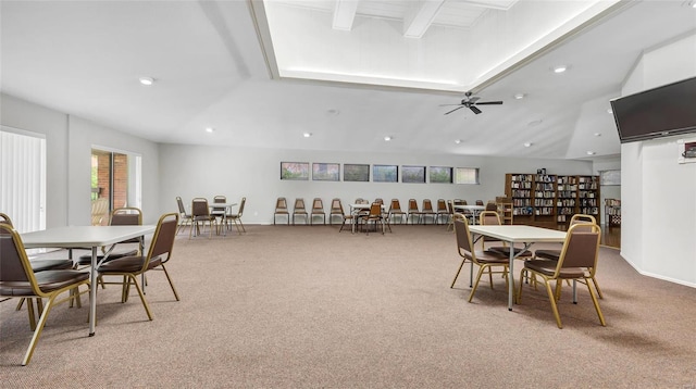 dining space featuring ceiling fan, beam ceiling, carpet, and a wealth of natural light