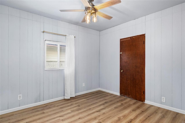 spare room featuring light hardwood / wood-style floors and ceiling fan