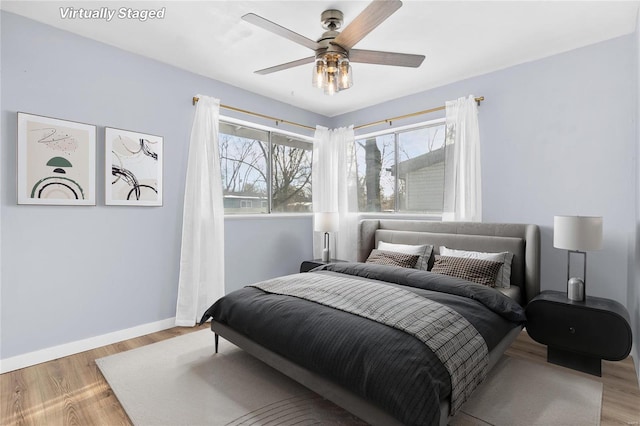 bedroom with ceiling fan and light hardwood / wood-style floors