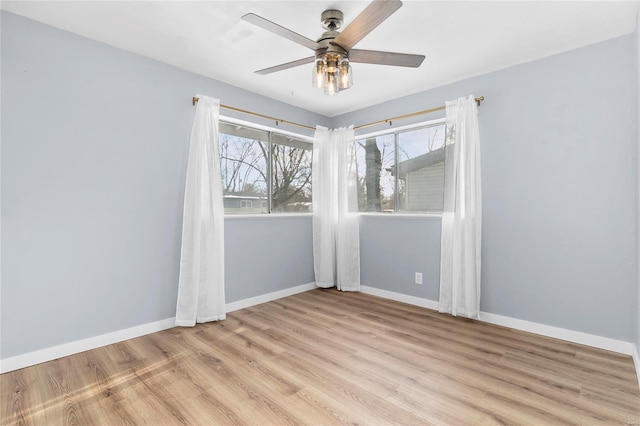 empty room featuring ceiling fan and light hardwood / wood-style flooring