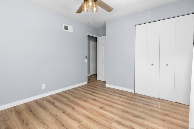 unfurnished bedroom with ceiling fan, a closet, and light hardwood / wood-style flooring