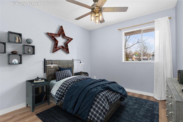 bedroom with ceiling fan and hardwood / wood-style floors