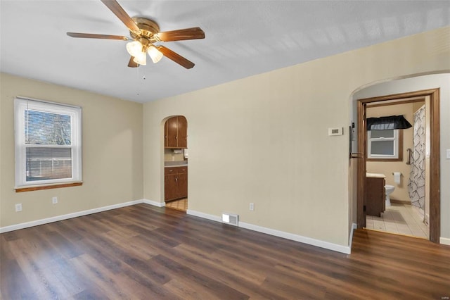 unfurnished room with dark hardwood / wood-style floors and ceiling fan