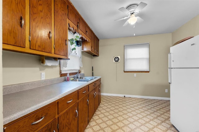 kitchen with white fridge, sink, and ceiling fan